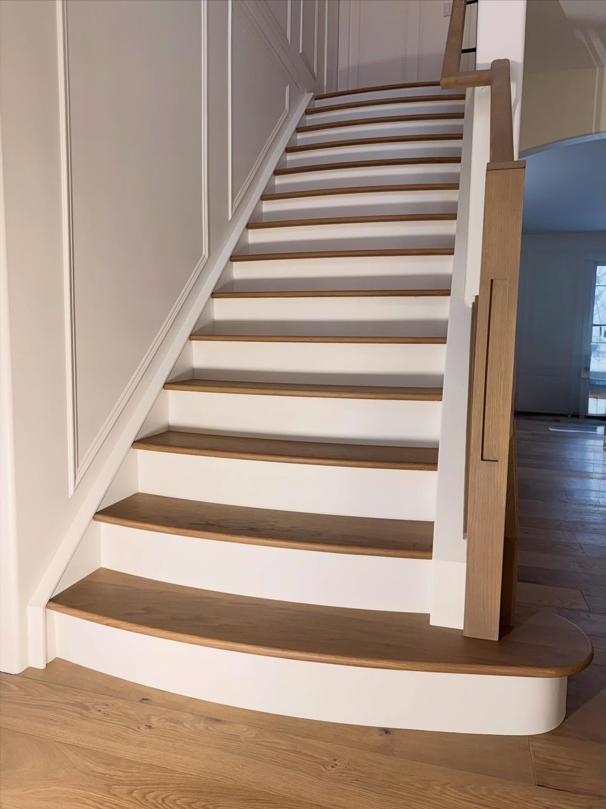 Curved hardwood tread fronts and the rounded bottom step.
