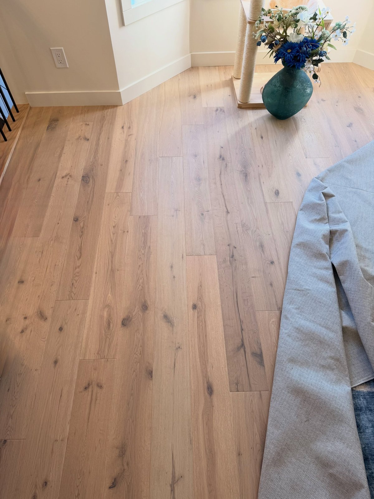 A close view of light wood-look planks with pronounced grain and staggered end joints.