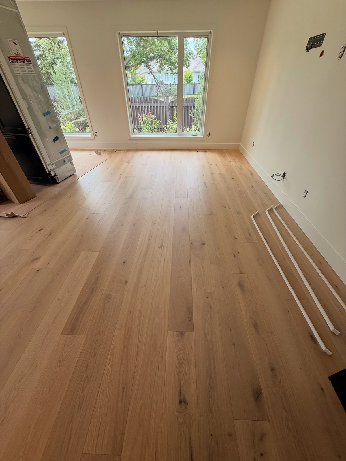 Light wood-look planks laid in staggered rows across a bright room.