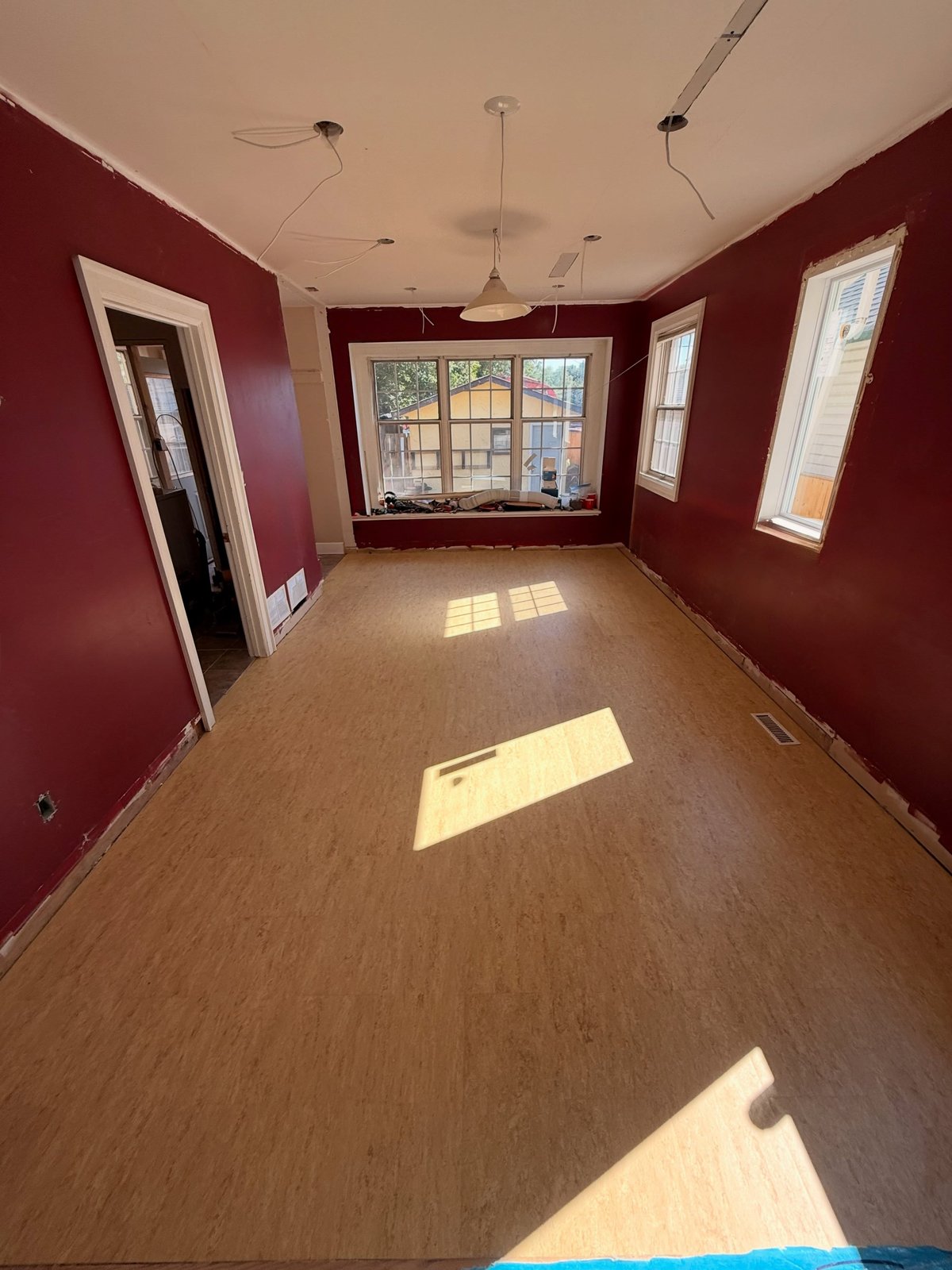 Warm-toned Marmoleum flooring with a mottled surface across the room.