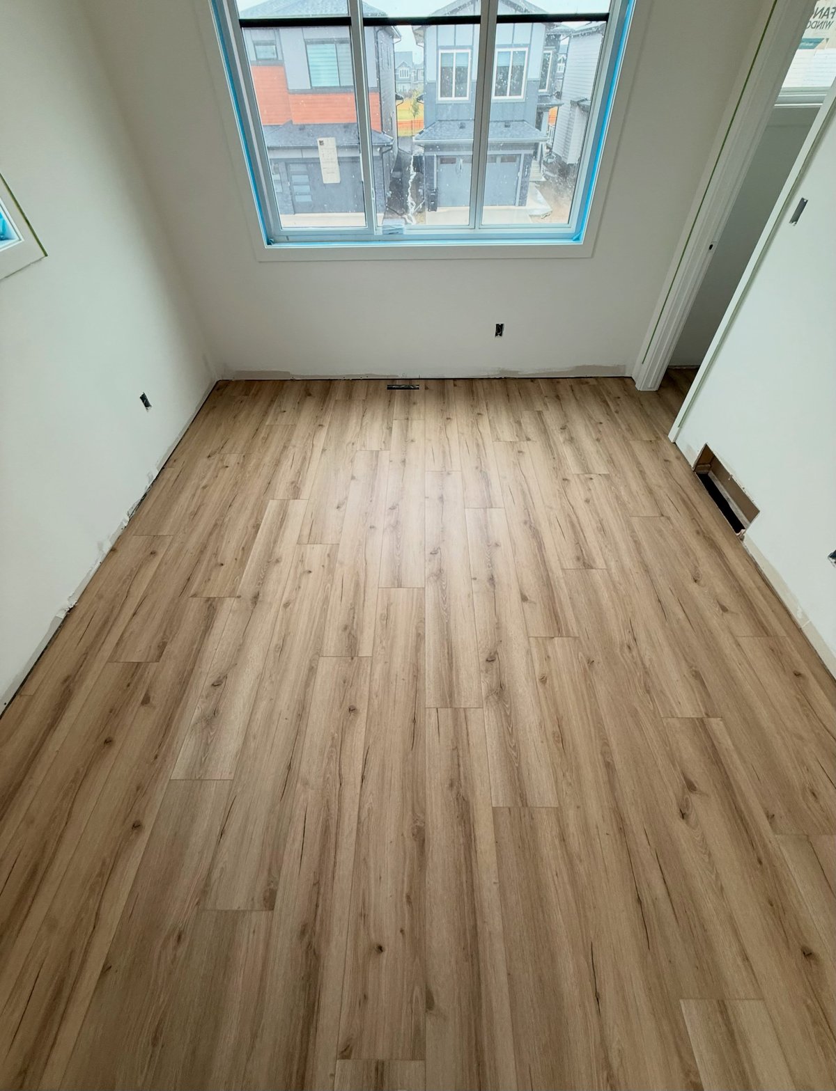 Light wood-look planks with varied grain, laid in staggered rows.
